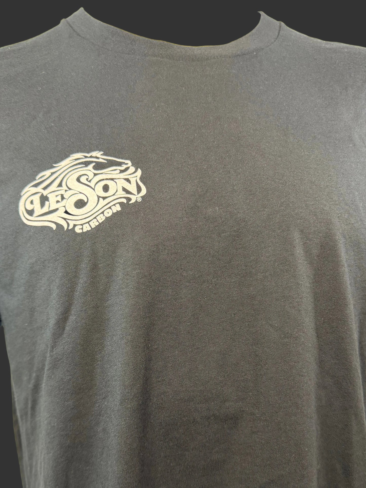 Black t-shirt with a logo on a mannequin against a plain background